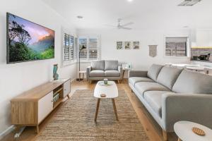 a living room with a couch and a table at Beach House 41 in Rosebud