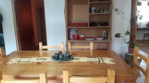 mesa de comedor con mesa de madera y sillas en El Jarillal Chalet de Montaña a pasos del lago en Lago Puelo