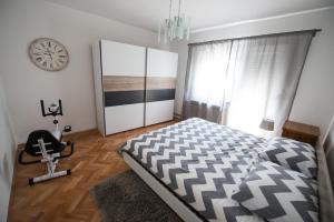 a bedroom with a bed and a clock on the wall at Aurora Zagreb in Zagreb