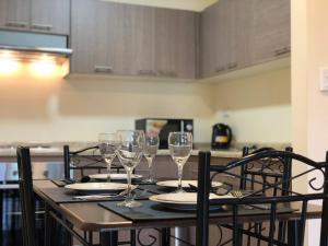 a table with wine glasses on it in a kitchen at Trotamundos in Puerto Natales