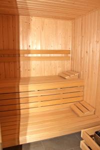 a wooden sauna with wooden shelves in it at The Rose Suites in Bruges