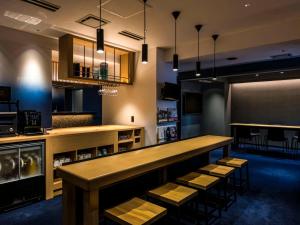 a restaurant with a bar with stools in a room at Hotel New Shohei in Tokyo