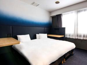 Postel nebo postele na pokoji v ubytování Hotel New Shohei
