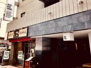 a store front of a building with signs on it at Hotel New Shohei in Tokyo