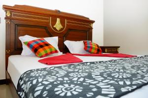 a bedroom with two beds with red pillows at Talalla 170 Villa in Talalla South