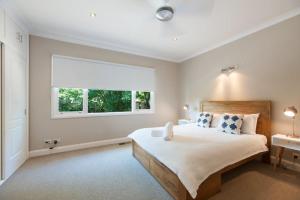 a bedroom with a large bed and a window at Murray House in Echuca
