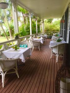 a restaurant with tables and chairs on a deck at Waterfront Lodge in Nuku‘alofa