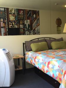 a bedroom with a bed and a desk with a fan at Flinders Street 238, CLEMENTS HOUSE at Federation Square, Melbourne, Australia in Melbourne