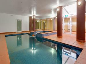 a large swimming pool in a building at Cowes Beachfront Retreat in Cowes