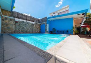 a swimming pool in the backyard of a house at RedDoorz near Walking Street Angeles City in Angeles