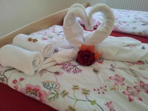 two swans made out of towels on a bed at Stübilerhof in San Giovanni in Val Aurina