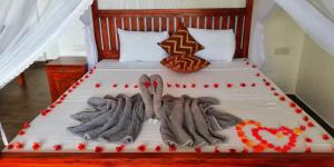 a bed with a cake on top of it at Divine View Homestay in Ella