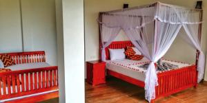 a bedroom with two beds with red and white furniture at Divine View Homestay in Ella
