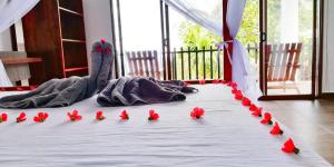 a group of red flowers on a bed at Divine View Homestay in Ella