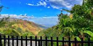 a fence in front of a view of a mountain at Divine View Homestay in Ella