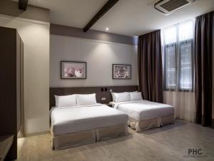 Säng eller sängar i ett rum på Hutton Central Hotel By PHC