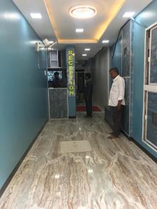a man standing in the hallway of a building at SM MANSION near Harbour & High court in Chennai