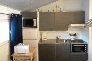 a small kitchen with a sink and a stove at Lomakylä Atimo in Alakitka
