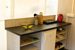 a kitchen counter with a black counter top at Glamping Tents | Losinj | Camp Čikat in Mali Lošinj