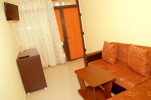 a living room with a couch and a table at Vila Maritimo in Mangalia