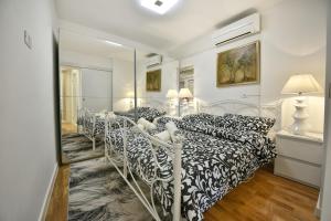 a bedroom with three beds and a mirror at Apartment Markovski in Poreč
