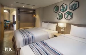 a hotel room with two beds and a dining room at Bahari Parade Hotel by PHC in George Town