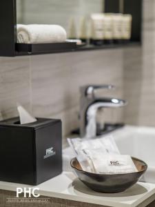 a bowl on a counter next to a bathroom sink at Bahari Parade Hotel by PHC in George Town