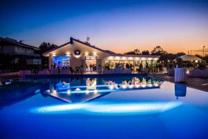 a wedding reception in front of a building at night at Riviera Del Sole Hotel Resort Spa in Piraino