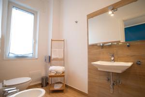 a bathroom with a sink and a toilet and a mirror at Vanvitelli Domus in Naples +42 photos