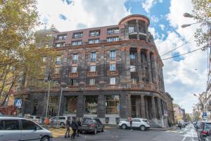 a large brick building on a busy city street at Umba Apartment N1 - 2 bedrooms in Yerevan