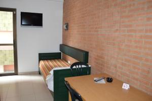 a room with a table and a brick wall at Apartaments Rosanna in Lloret de Mar
