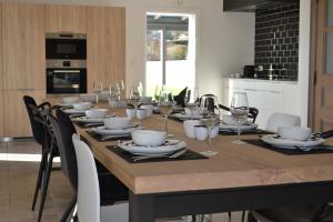a long table with glasses and plates on it at Vue d'en Haut in Durbuy