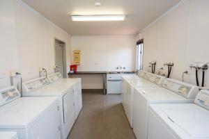 a bathroom with white sinks in a room at Latitude20 Roebourne Village in Roebourne