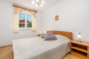 Posteľ alebo postele v izbe v ubytovaní Villas Kampor