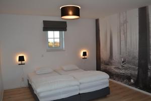 a bedroom with a bed and a painting on the wall at Vue d'en Haut in Durbuy +33 photos