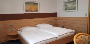 a bed in a room with two white pillows at Hotel Habana in Aalen