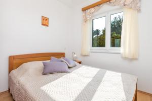 Posteľ alebo postele v izbe v ubytovaní Villas Kampor