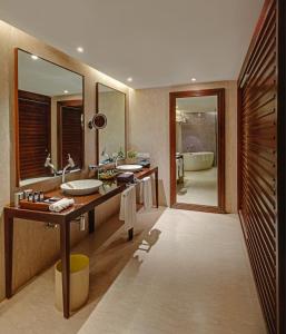 a bathroom with two sinks and a large mirror at The Park Visakhapatnam in Visakhapatnam
