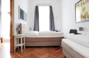 a bedroom with a bed and a chair and a window at Apartment KATZBACH - Cozy Family & Business Flair welcomes you - Rockchair Apartments in Berlin