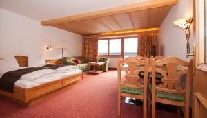 a hotel room with a bed and a balcony at Appartementhaus Leitner in Ehrwald