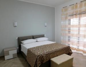 a bedroom with a bed and a large window at Bed and Breakfast Acrobatic in Villa San Giovanni +16 photos