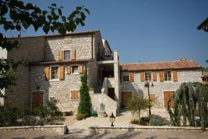 a large stone house with a courtyard at Apartments Villa Stapo in Umag