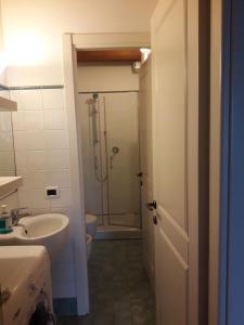 a bathroom with a shower and a sink and a toilet at IMMERSA NEL VERDE in Osimo