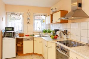 a kitchen with a sink and a stove at Weidenweg 06 in Ostseebad Karlshagen
