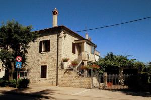 a stone building with a lighthouse on top of it at Studios Slavica in Novigrad Istria