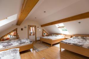 a room with three beds in a attic at Apartment Velbana Gorca in Virštanj