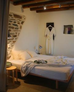 a bedroom with a bed and a dress hanging on the wall at Alitanes in Ano Meria