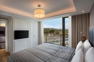 a bedroom with a bed and a large window at The Grand Tarabya Hotel in Istanbul
