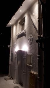 a building with lights on the side of it at night at Neno in Zagreb