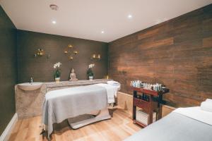 a bathroom with two beds and a sink and a tub at Best Western Plus The Connaught Hotel and Spa in Bournemouth